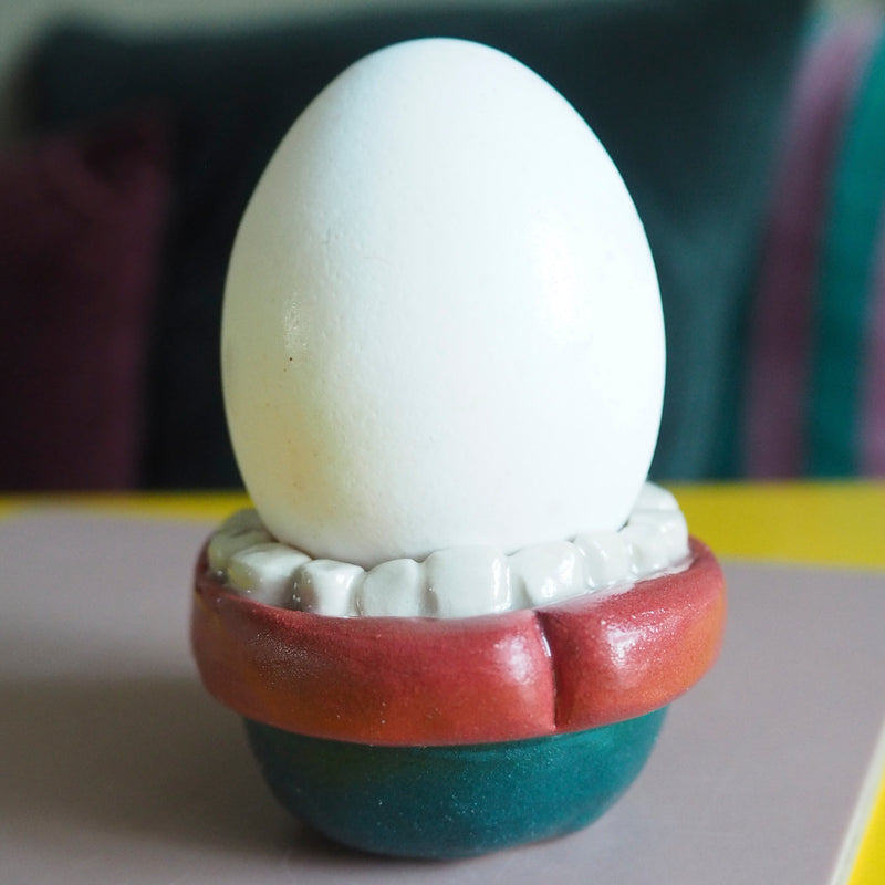 Open the egg cup/bowl with the mouth open