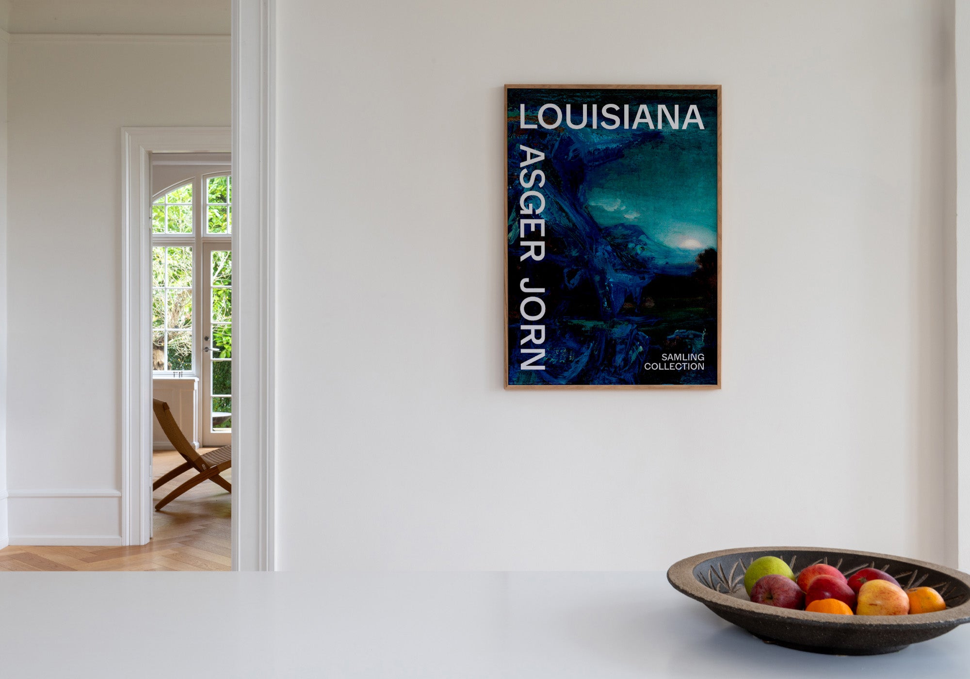 Kunstplakat med Asger Jorns farverige værk i blå nuancer stylet på væg i hjem. Louisiana Museum of Modern Art, 2026.
